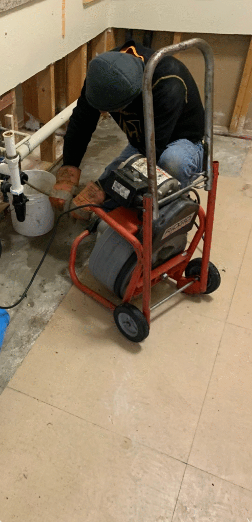 Plumber performing drain cleaning with professional auger in Las Vegas NV