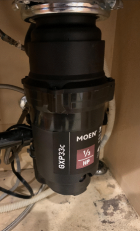 Compact Moen 1/3 HP garbage disposal installed under sink in Las Vegas NV home