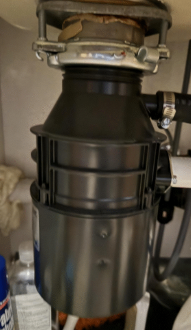 Compact Moen 1/3 HP garbage disposal installed under sink in Las Vegas home