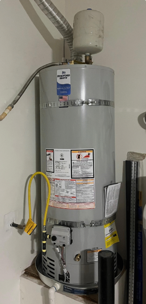 Tall gas water heater installed on a raised platform in Las Vegas NV with expansion tank, venting duct, and gas line connections