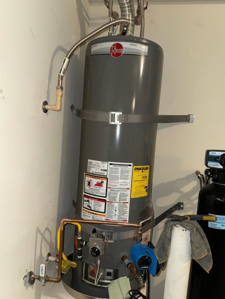 Professional water heater replacement in Las Vegas NV showing gas water heater, expansion tank, and safety strapping