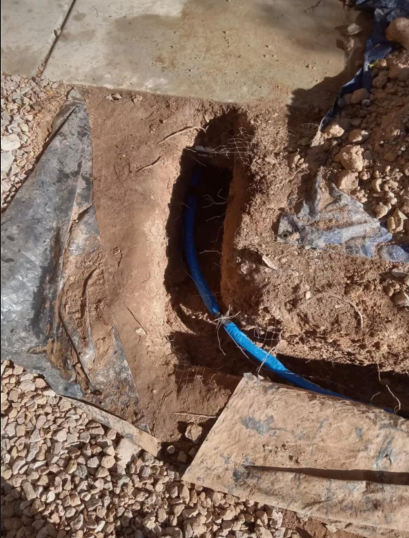 Underground blue water service line repair in Las Vegas NV with trench excavation near foundation