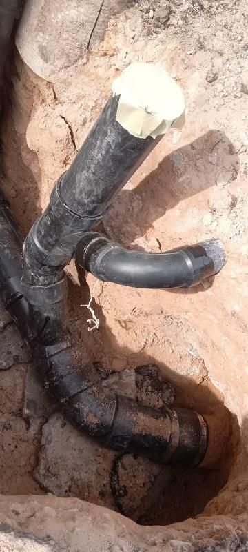 Damaged sewer pipe in trench showing elbow joint during sewer line repair Las Vegas