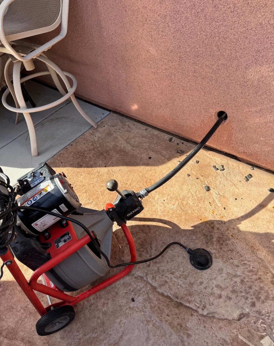 Drain cleaning machine being used to clear an outdoor drain in Las Vegas, NV
