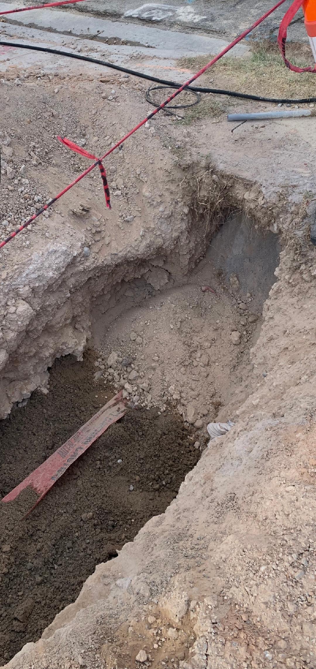 Deep excavation to locate and repair underground slab leak with safety barriers in Las Vegas, NV
