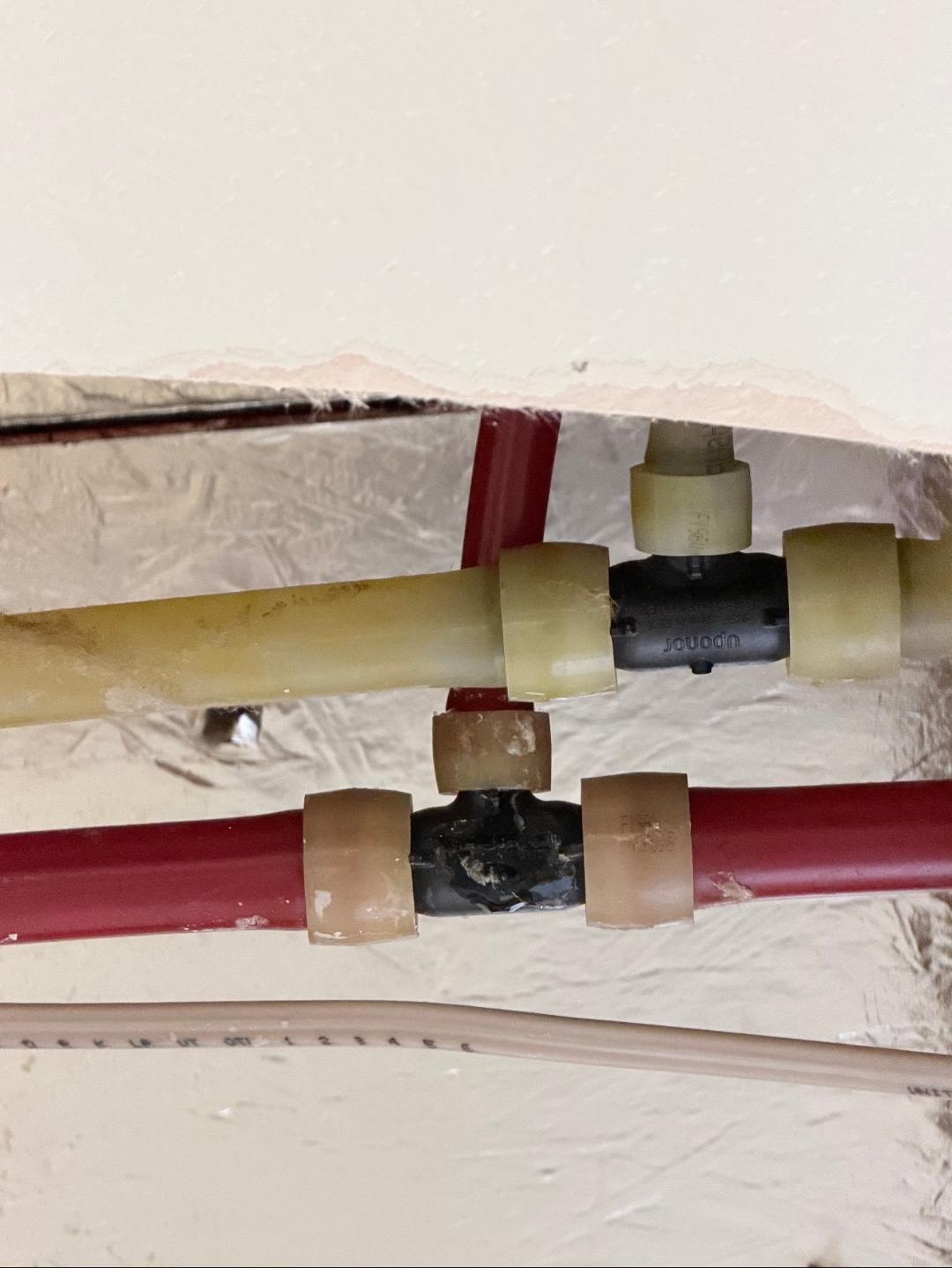 Hot and cold water lines with push fit fittings repaired behind wall during water line repair service in Las Vegas, NV
