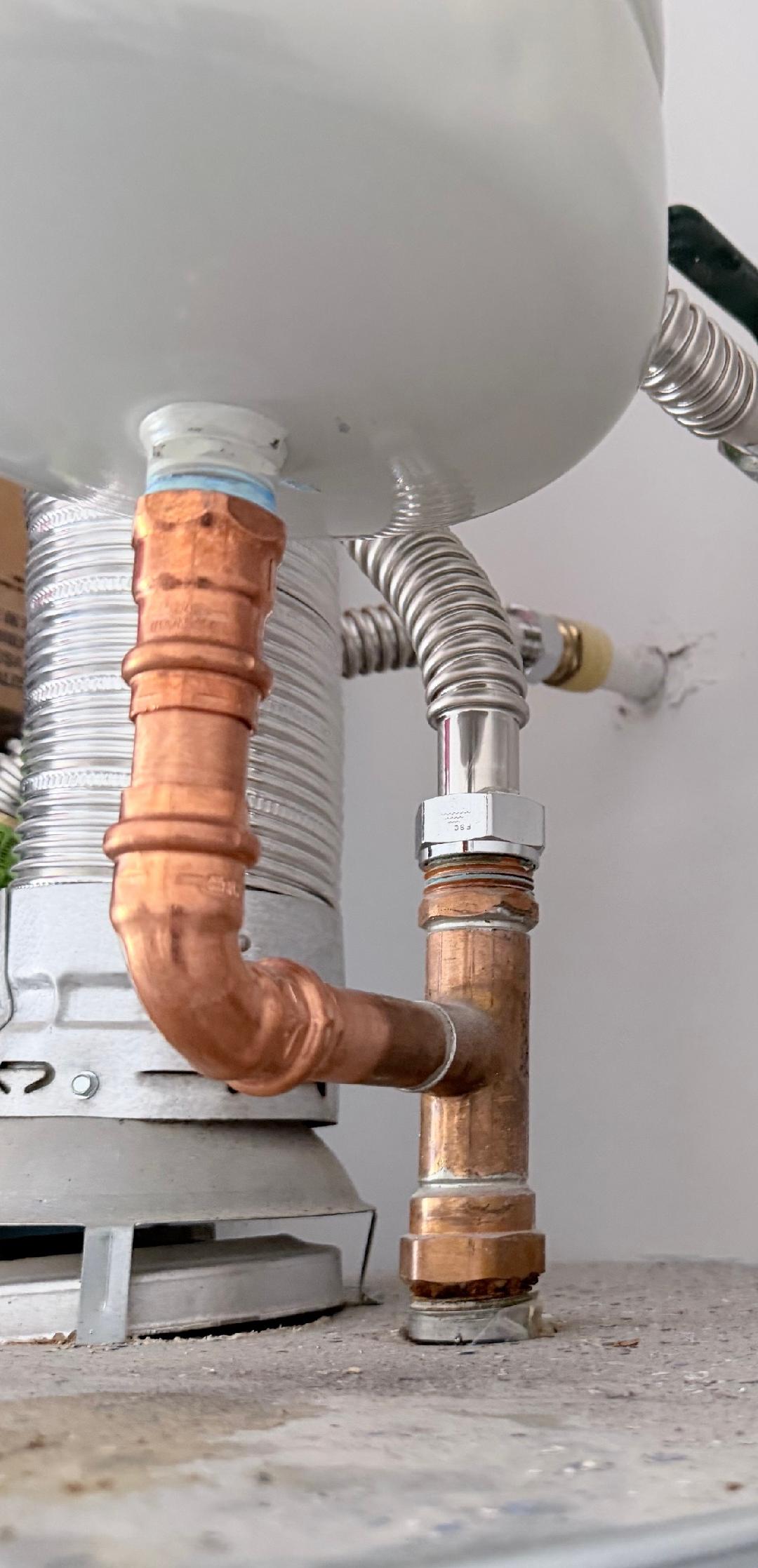 Copper pipe and flexible water supply line connections at base of water heater installation by Plumbing Repair Experts in Las Vegas, NV