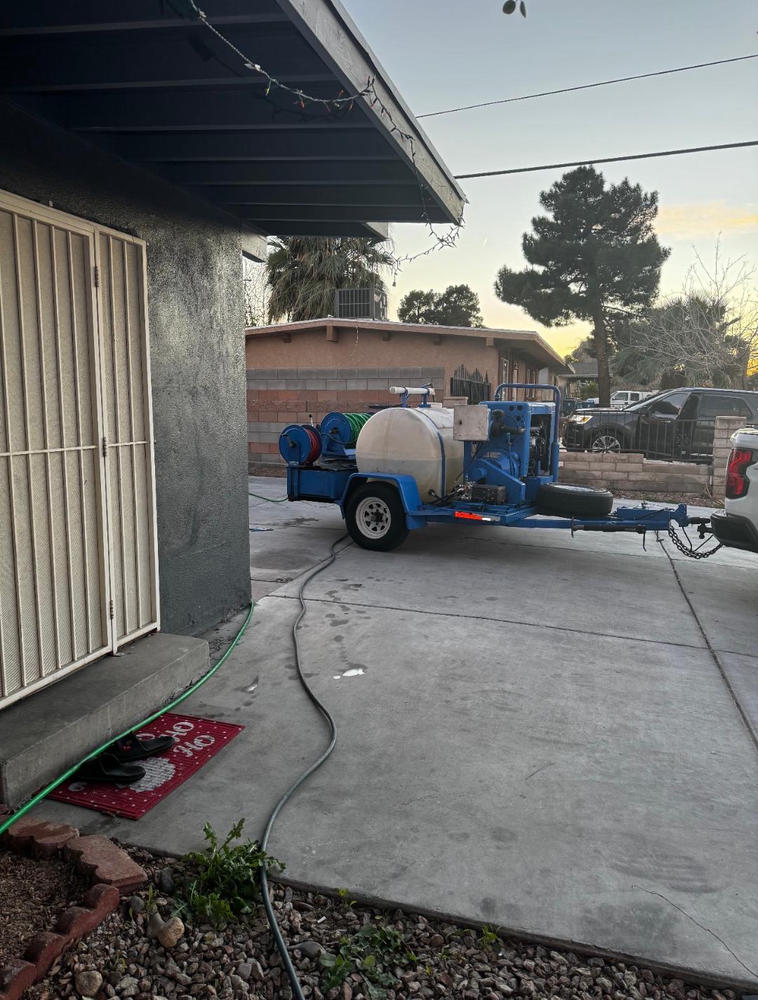 Plumbing Repair Experts hydro jetting trailer parked at residential driveway during drain cleaning service in Las Vegas, NV