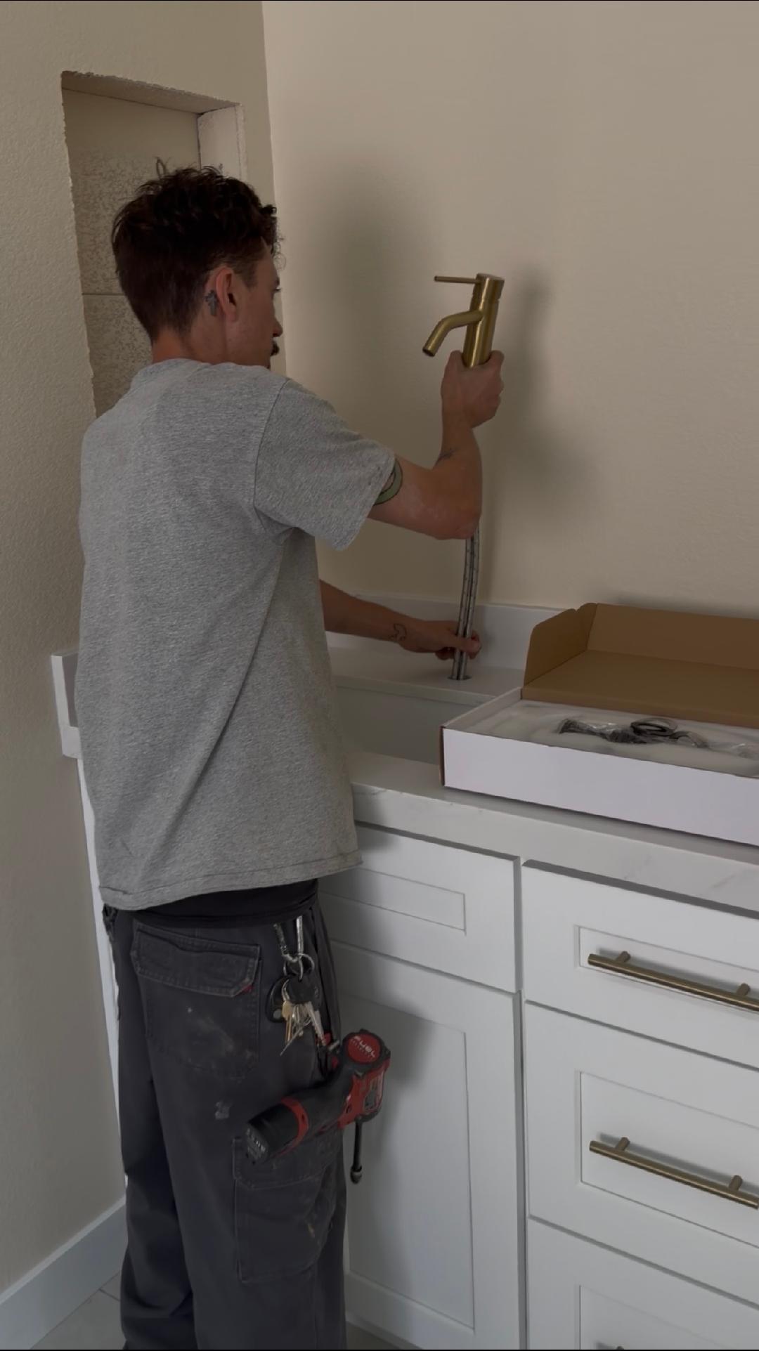 Plumbing company Las Vegas technician installing bathroom faucet