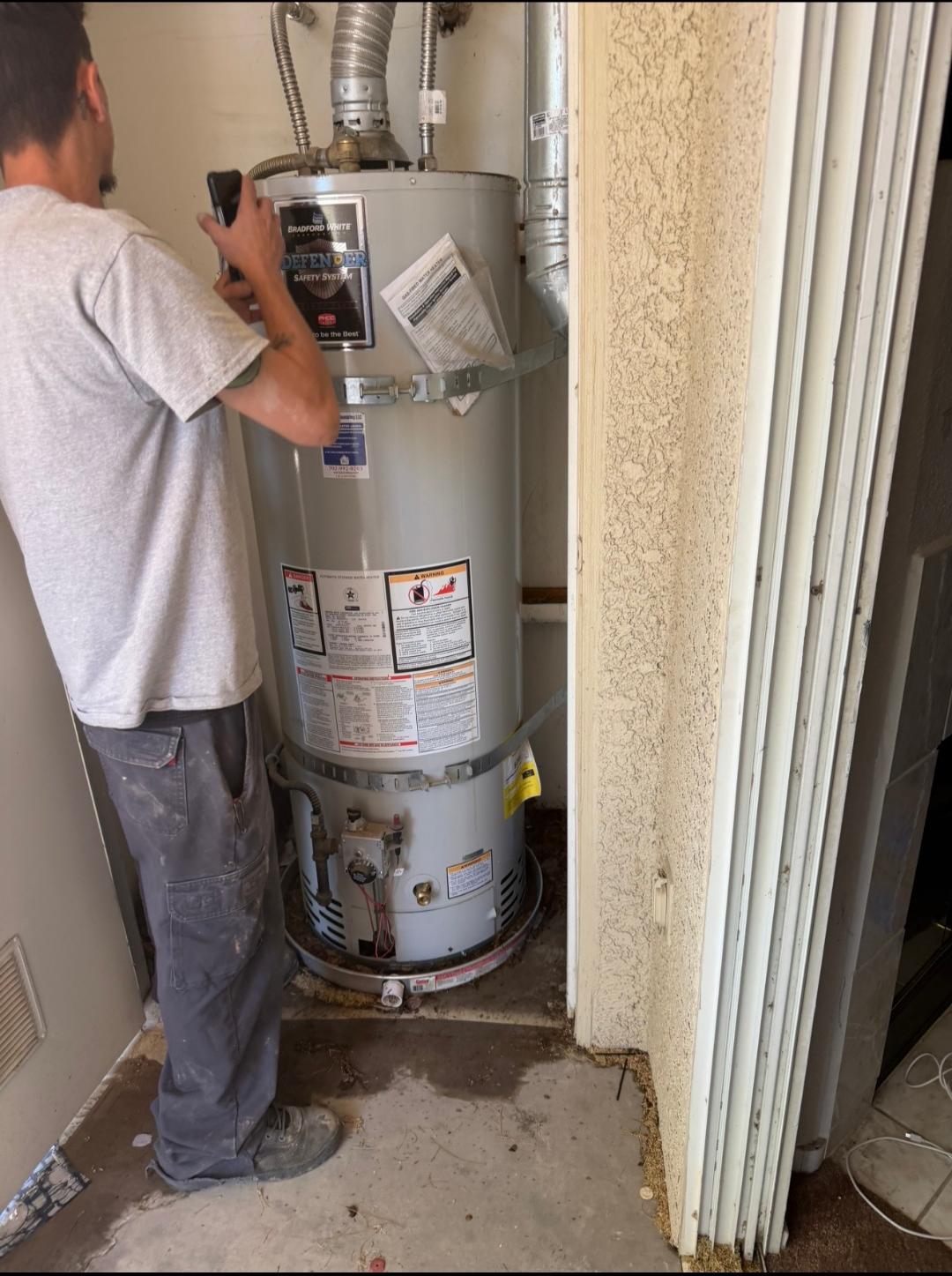 Plumbing Repair Experts technician inspecting Bradford White Defender Safety System water heater during service call in Las Vegas, NV