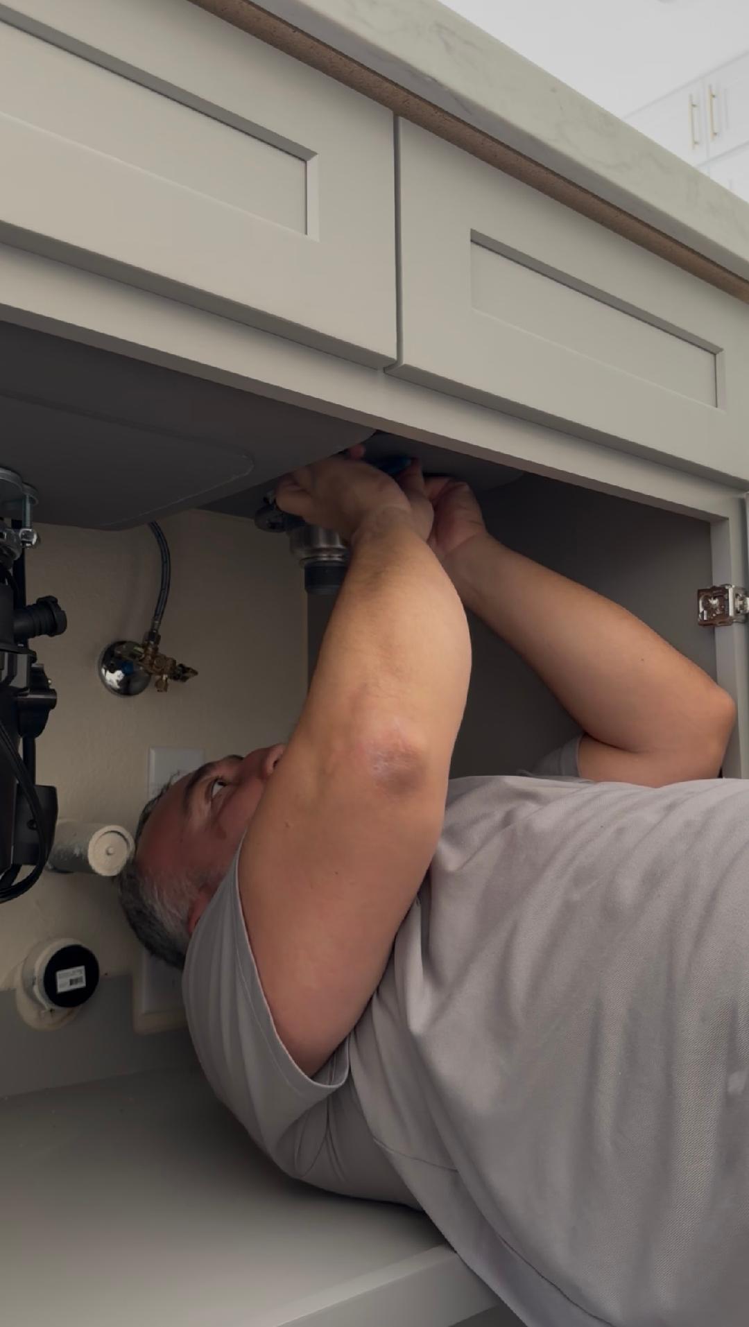Plumbing Repair Experts plumber installing kitchen faucet under sink cabinet in Las Vegas, NV