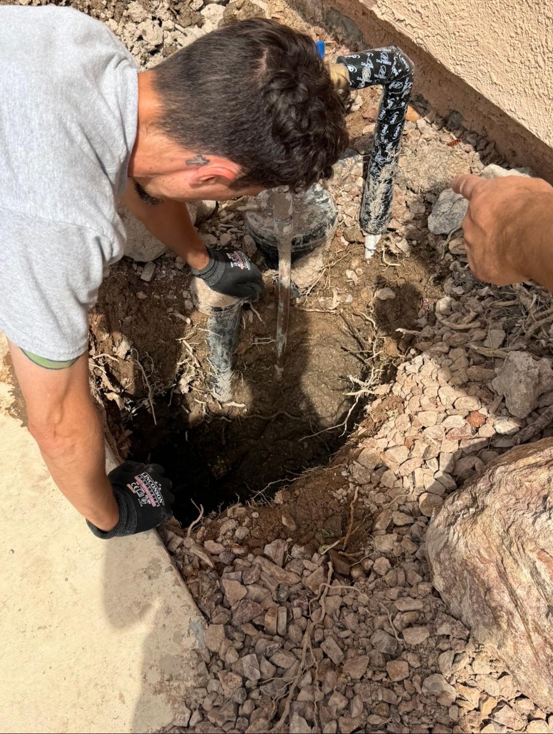 Plumbing Repair Experts technician repairing leaking water line at foundation of Las Vegas NV home with active water leak